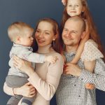 A joyful family portrait showcasing parents and their two children, expressing love and togetherness.